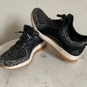 Black and white Adidas boost athletic shoes